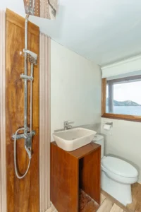 Upper-deck sharing cabin aboard Sora phinisi with single bunk beds