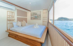Signature private cabin aboard Sora phinisi with double bed and ensuite bathroom
