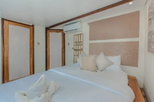 Signature private cabin aboard Sora phinisi with double bed and ensuite bathroom