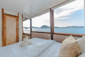 Signature private cabin aboard Sora phinisi with double bed and ensuite bathroom