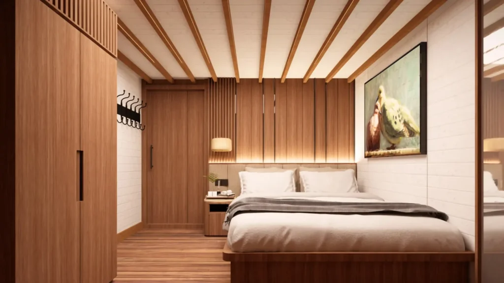 Merpati Deluxe cabin on Sukha Sail 2 with king bed and porthole view