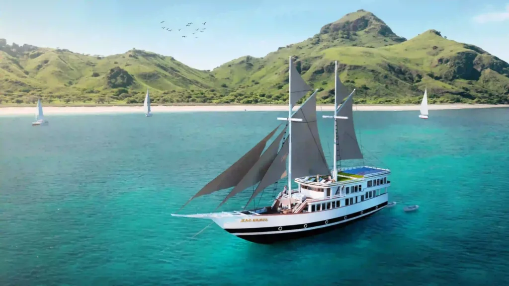 Aerial view of Sukha Sail 2 phinisi cruising a sheltered Komodo bay