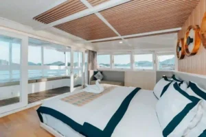 Interior of the Tara master cabin with double bed and panoramic outlook