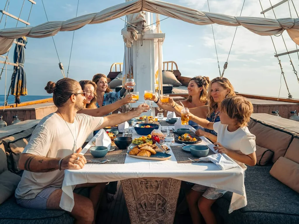 Guests dining alfresco on the deck of The Oracle yacht