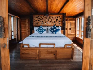 First Suite Room aboard The Oracle with king bed and panoramic windows