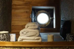 Bathroom vanity with porthole in The Oracle Luxe Room