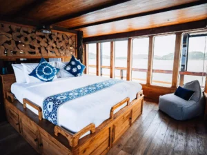 Second Suite Room aboard The Oracle with king bed and panoramic windows
