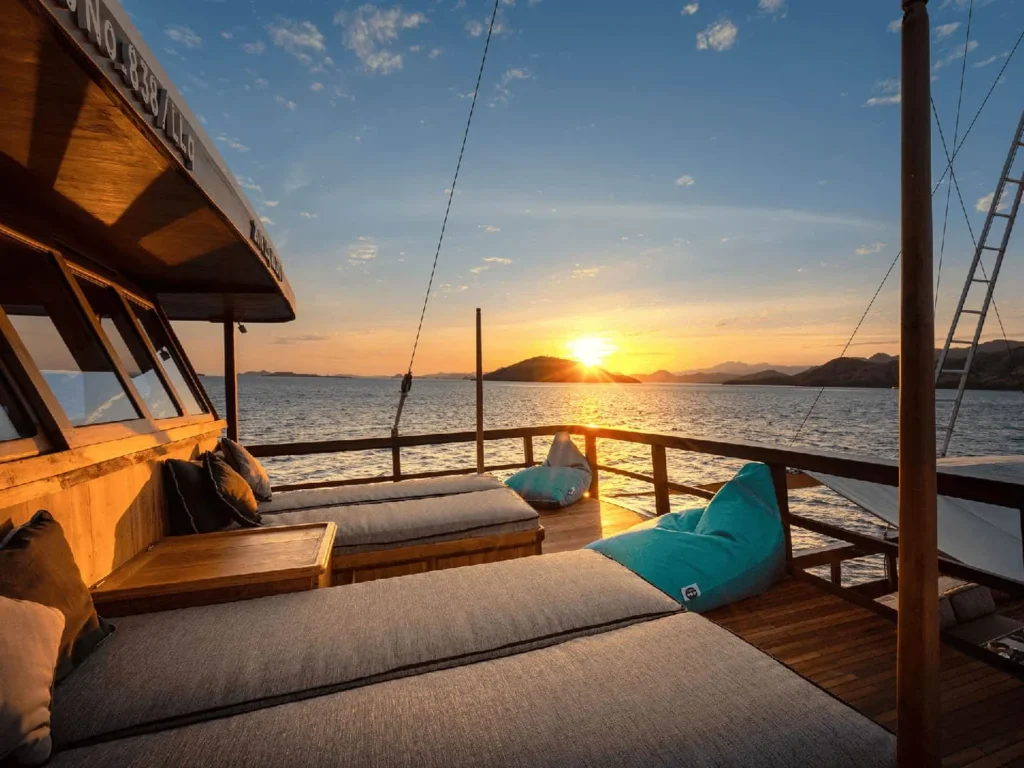 Sundeck daybeds aboard The Oracle yacht at sunset