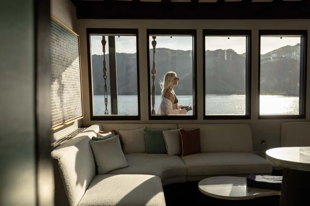 Guest lounge with panoramic windows aboard Vela