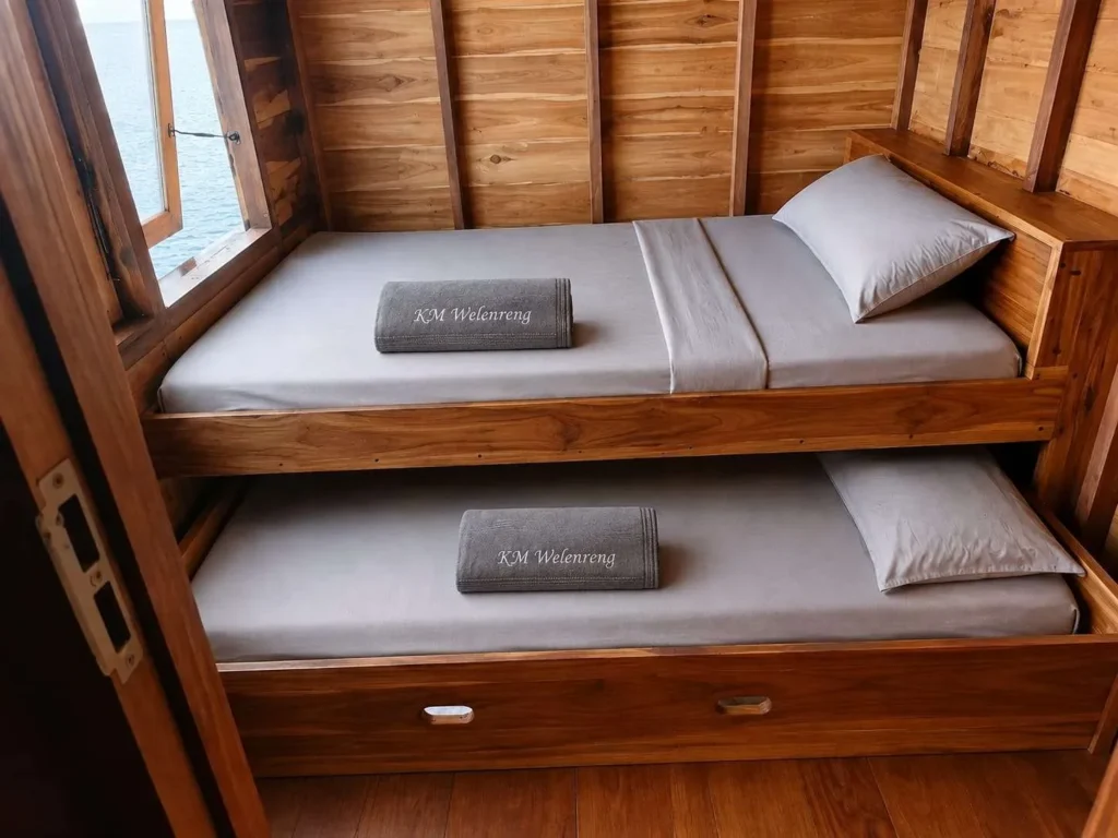 Main-deck sharing cabin on KLM Walenreng with berths and timber cabinets