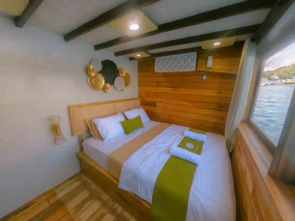 Double cabin with gold round wall decor and window aboard Yumana