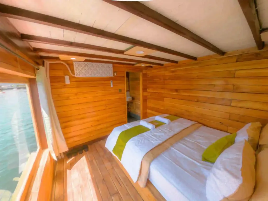 Upper-deck Signature cabin on Yumana with a queen bed and sea view