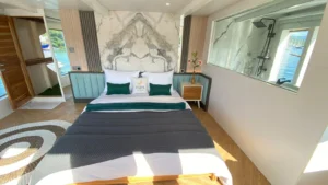 Master Cabin bed beside the glass-walled ensuite bathroom on Zada Ulla