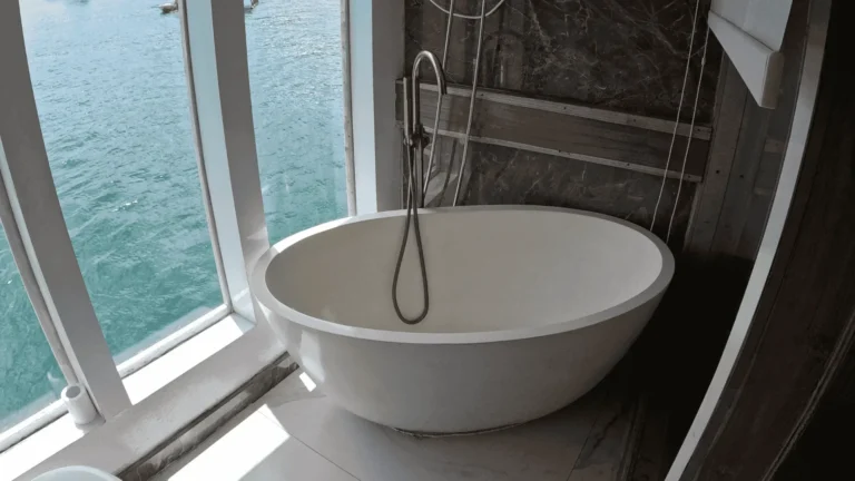 Ocean-view outdoor bathtub beside a Zada Ulla Suite Cabin