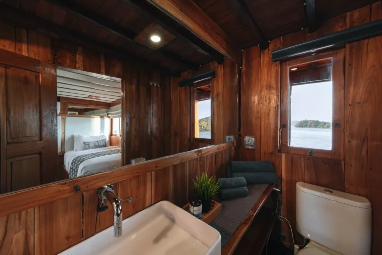Ensuite bathroom for Augustine twin cabin with wooden vanity and white tiled shower