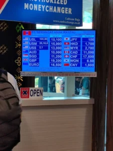 Cash X Change authorized money changer rate board in Labuan Bajo