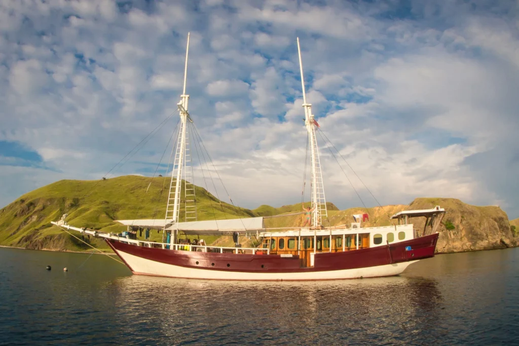 EcoPro Duyung Baru red and white liveaboard in profile near Komodo islands