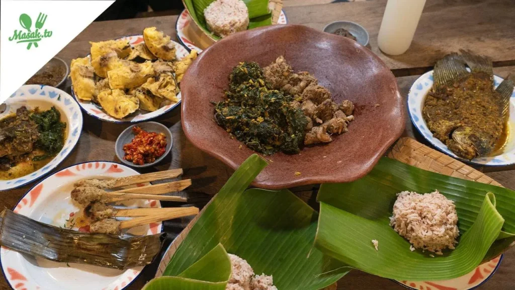 Fried dishes, sambal and rice served on banana leaf at Gedong Bajo Kitchen