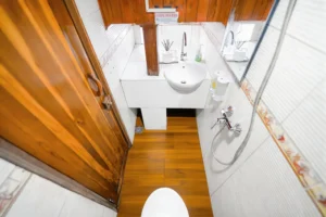 White tiled double cabin bathroom with sink aboard Lady Denok