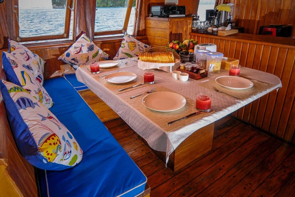 Breakfast table and blue cushioned seating in the Lady Denok indoor dining room