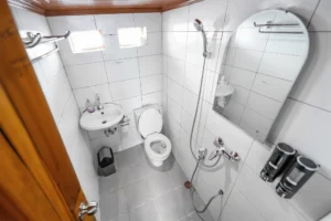 White tiled master cabin ensuite with shower and sink aboard Lady Denok