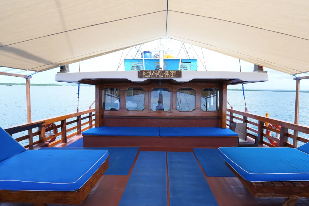 Blue cushioned loungers under the shaded sun deck of Lady Denok