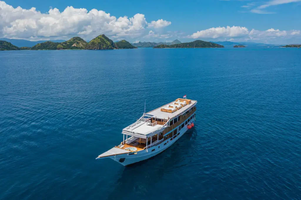 Wide aerial view of Malca Voyages with Komodo islands behind