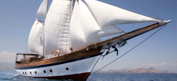 Mantra Phinisi under sail on calm Indonesian waters