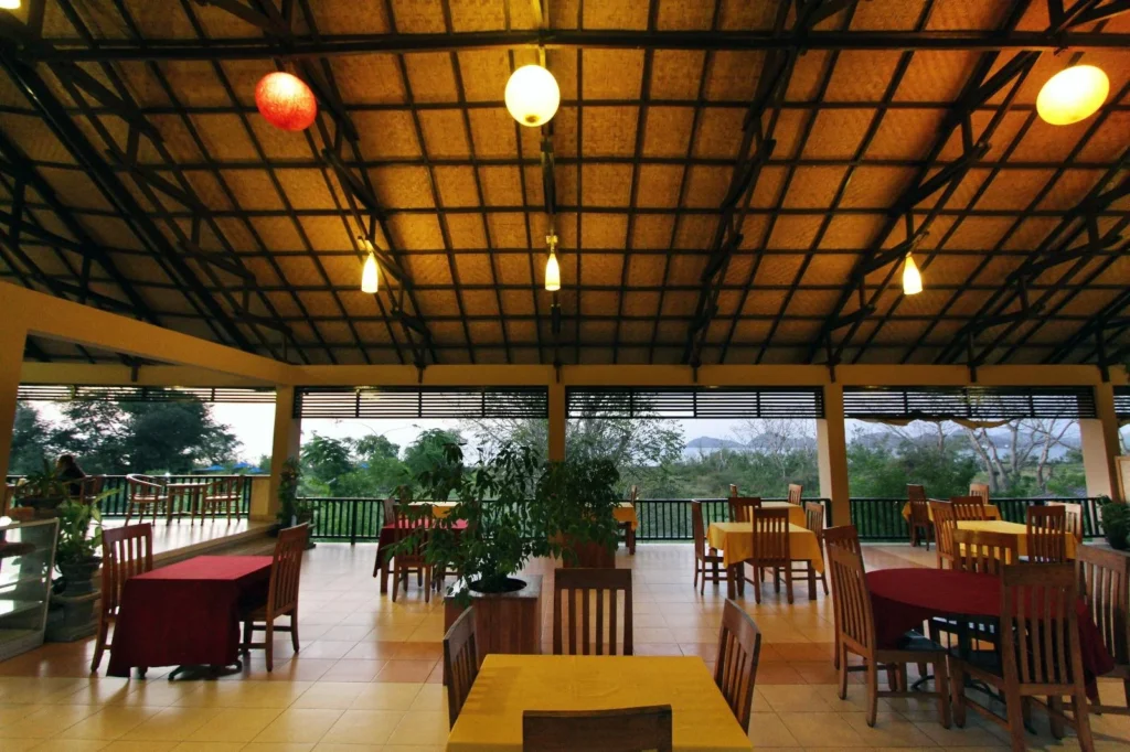 Open-sided wooden dining pavilion with tables at Puri Sari Restaurant