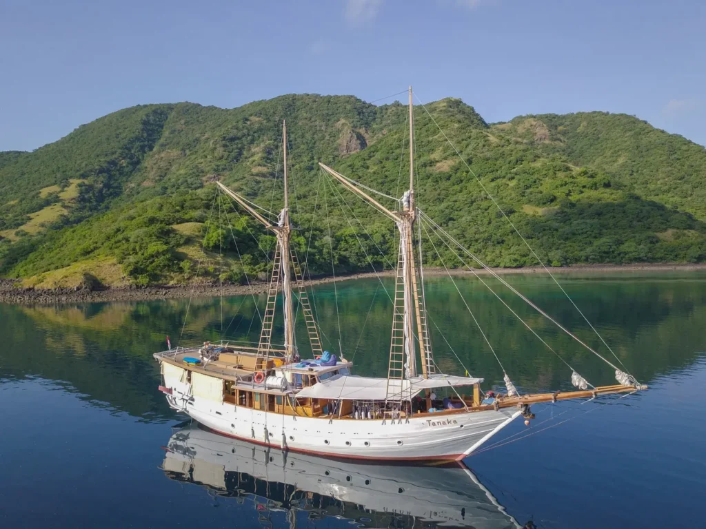 Aerial side view of Tanaka Phinisi on calm Indonesian waters