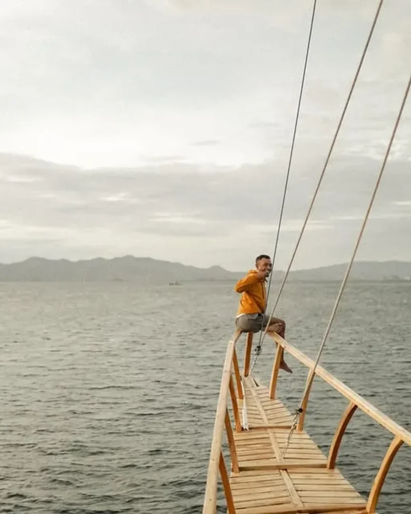 Guest standing on the bow of Yukai liveaboard at sea